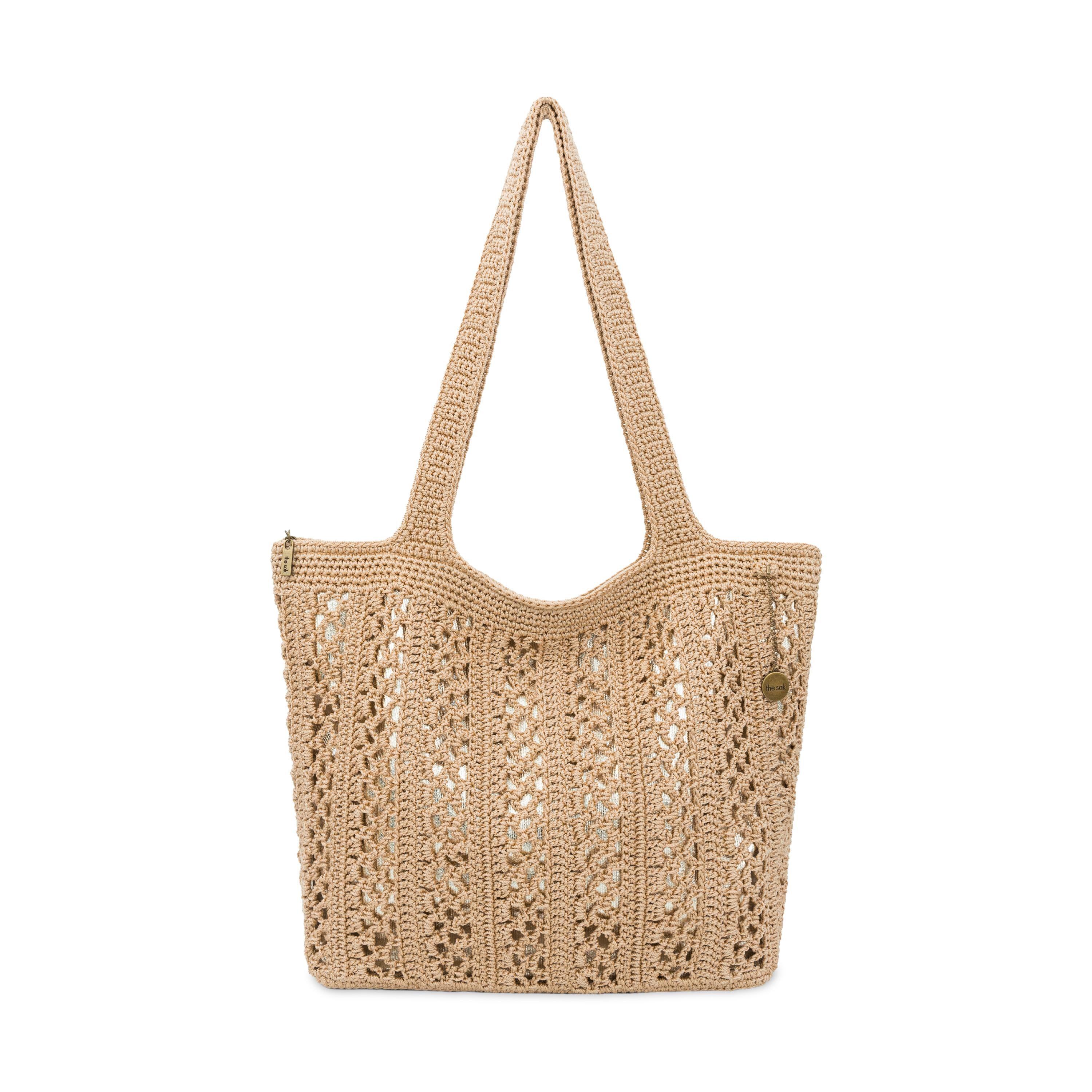 Tan crocheted tote bag with openwork pattern and long shoulder straps.